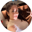 Smiling woman with dark hair wearing a cream top in a circular profile photo.